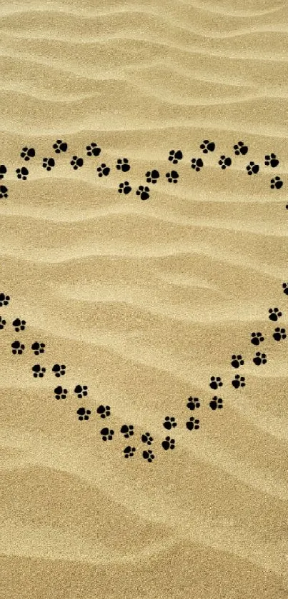 Sandy heart with paw prints forming a cute design on the beach.