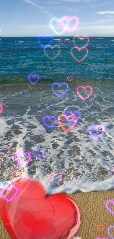 A vibrant red heart on a sandy beach with blue ocean waves and sky.