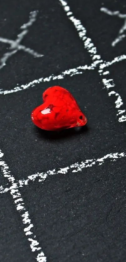 Red heart on a black chalkboard grid.