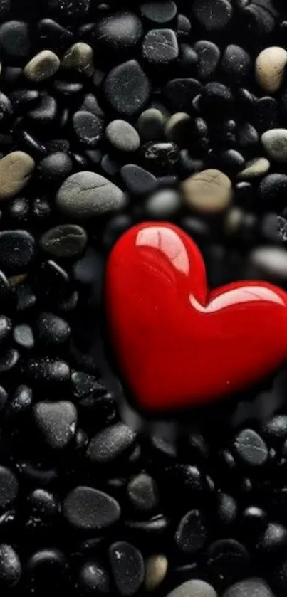 Red heart on black pebbles wallpaper for mobile. Perfect for romantic themes.