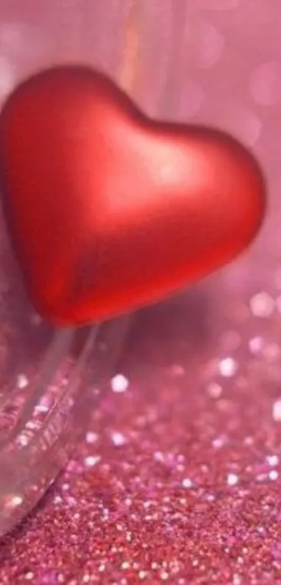 Red heart on a pink glittery surface wallpaper.