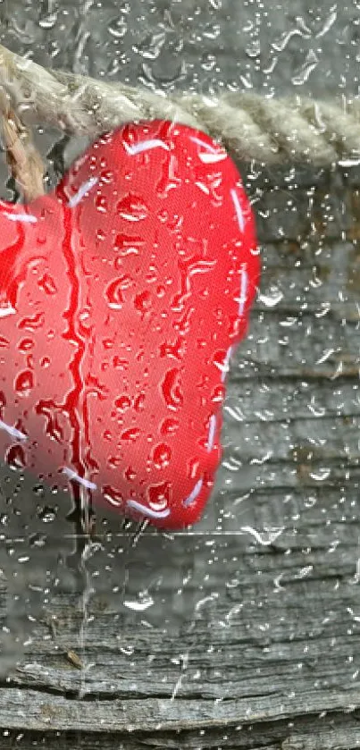 Red heart hanging on wood with raindrops