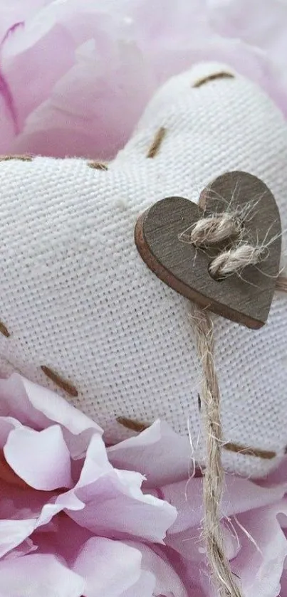 Fabric heart on pink flower petals, creating a romantic and gentle vibe.