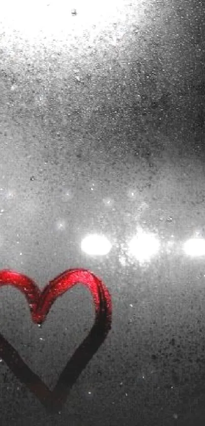 Heart drawn on a steamy window with city lights in the background.
