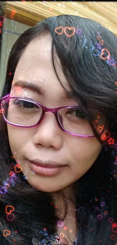 Mobile wallpaper with heart overlays and a close-up portrait with purple glasses.