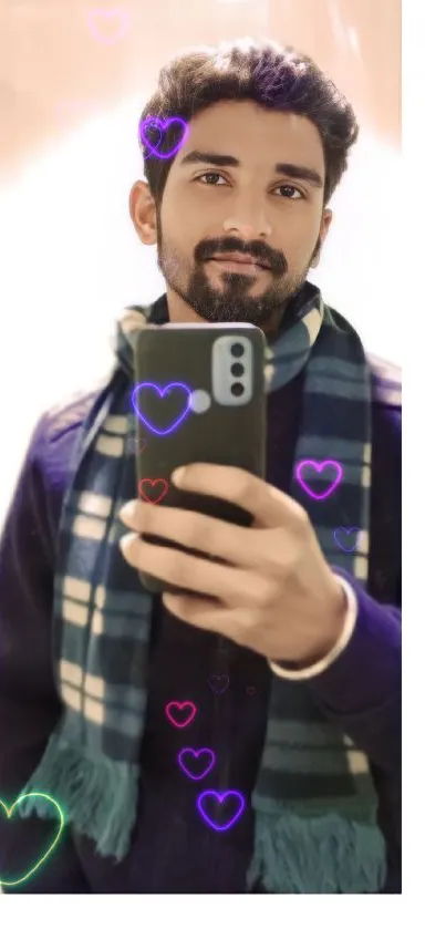 Selfie with colorful heart overlays on phone screen.