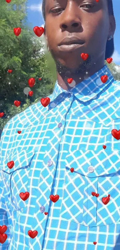 Man in blue patterned shirt with red hearts overlay.