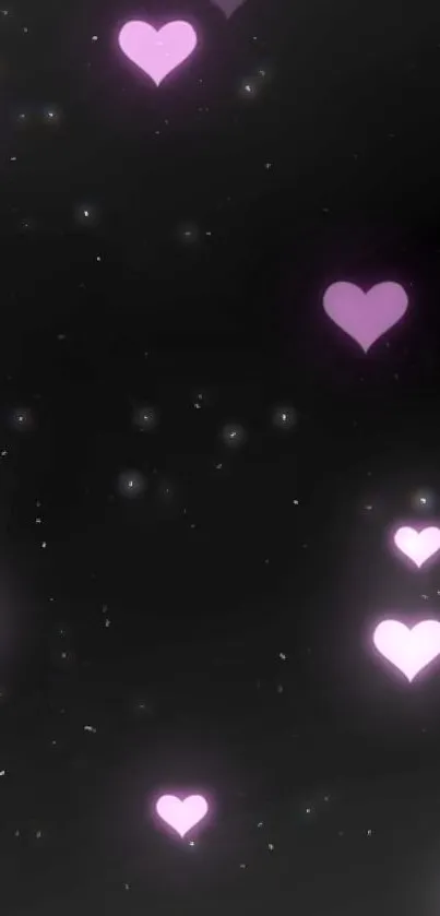 Glowing pink hearts on dark background wallpaper.