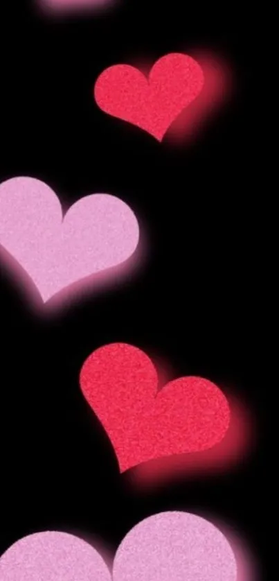 Mobile wallpaper with red and pink hearts on a black background.