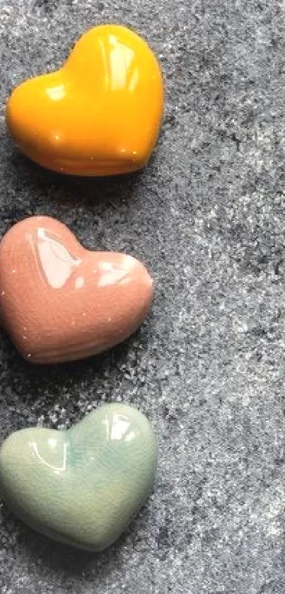 Gray stone background with colorful ceramic hearts.