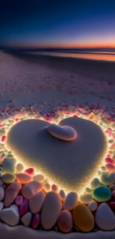 Heart-shaped sand art illuminated on a beach during sunset with colorful stones.