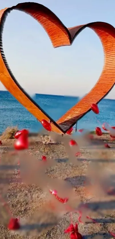 Wooden heart sculpture by the ocean with red accents on the shore.