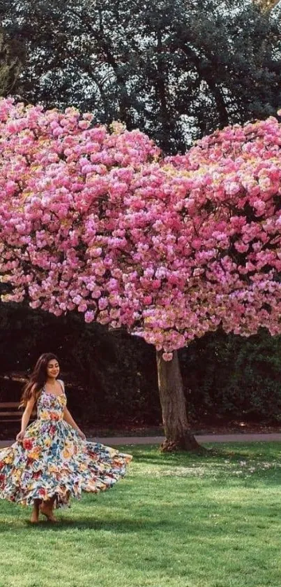 A woman twirls under a heart-shaped pink blossom tree in a park.