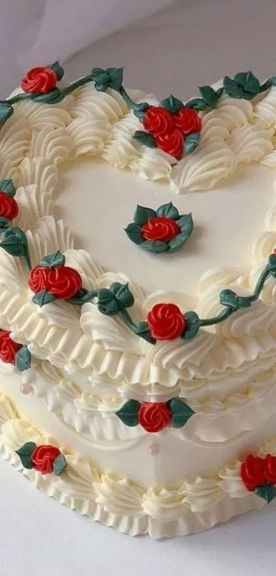 Heart-shaped cake with red roses and cream frosting.