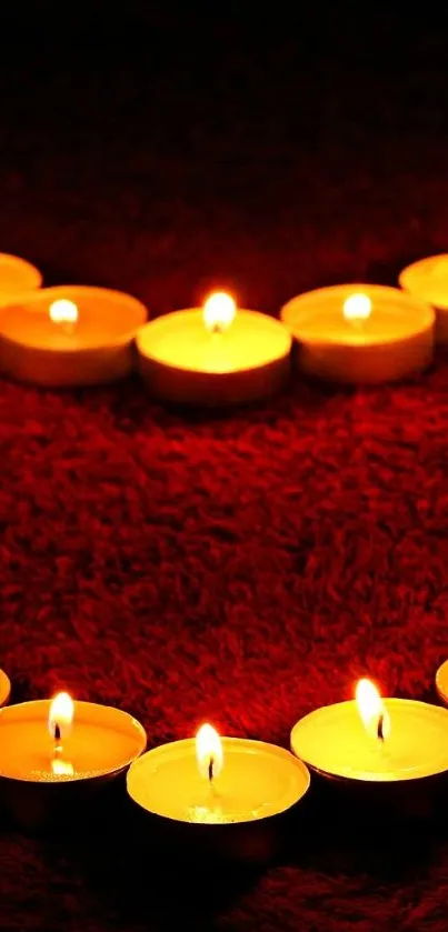 Heart-shaped candle arrangement on a red background.