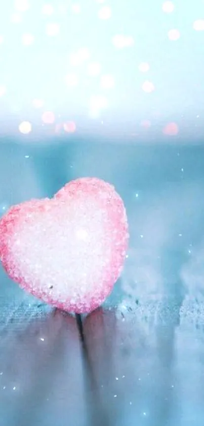 Heart-shaped candy on blue wood with bokeh lights.