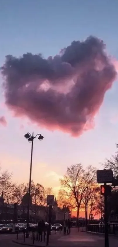 Heart-shaped cloud under a vibrant sunset sky.