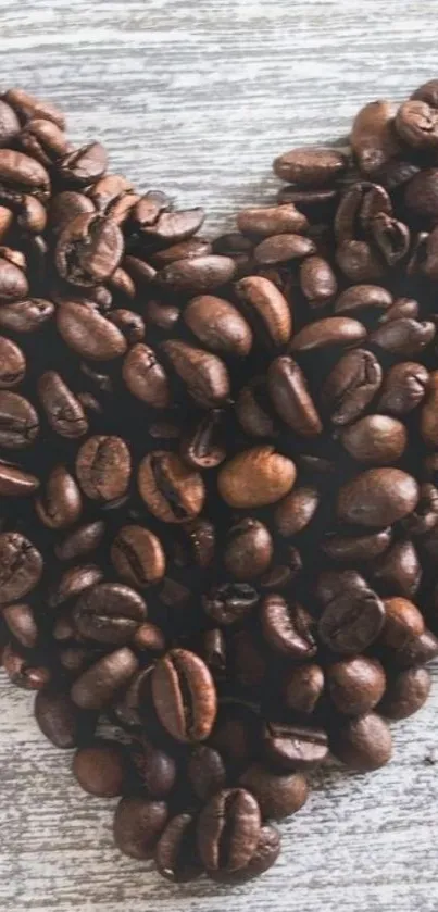 Heart-shaped coffee beans on wood background.