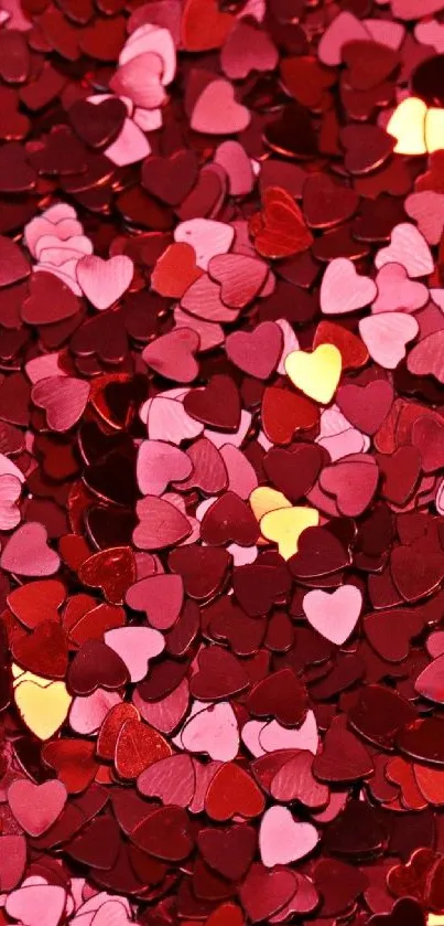 Heart-shaped confetti in red, pink, and gold on a mobile wallpaper.