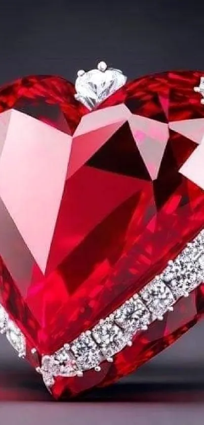 Heart-shaped red gemstone adorned with silver accents on a mobile wallpaper.