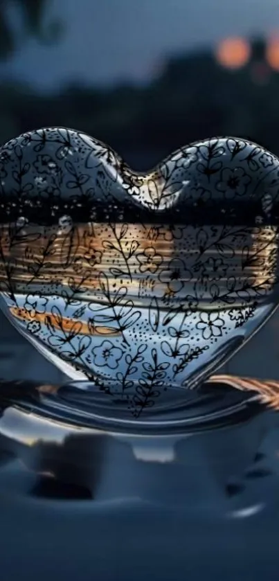 Heart-shaped glass with floral design reflecting in water.
