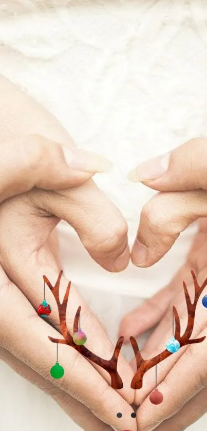 Heart-shaped hands with antlers and ornaments on a mobile wallpaper.