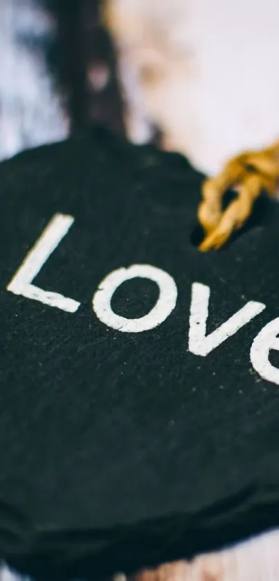 Heart-shaped slate with 'Love' in white on rustic background.