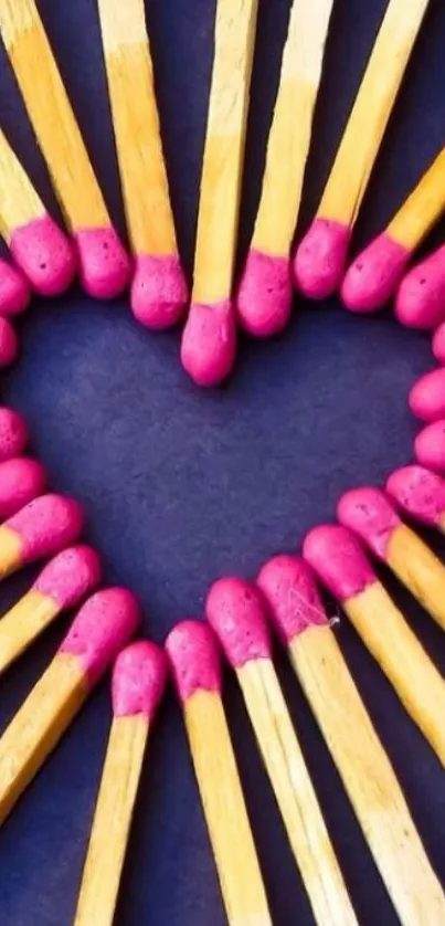 Heart-shaped matchstick design with red tips on black.