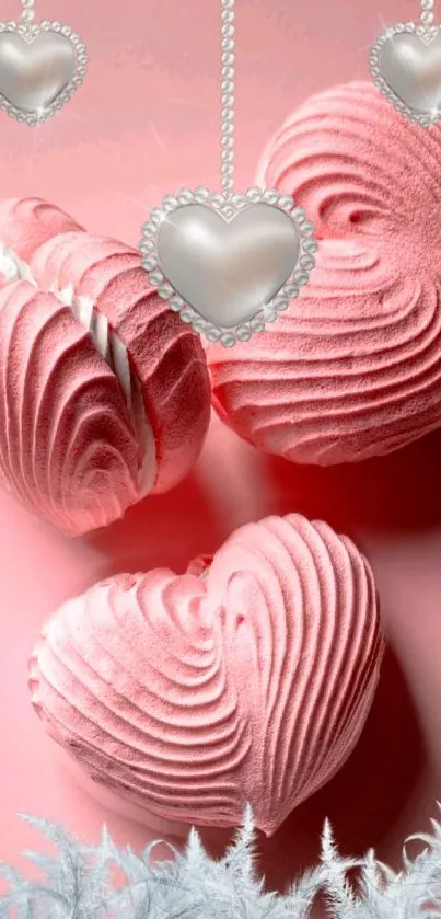 Heart-shaped pink desserts with dangling chains on a mobile wallpaper.