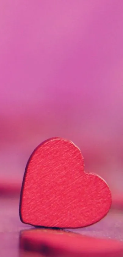 Pink heart-shaped mobile wallpaper with vibrant hues.