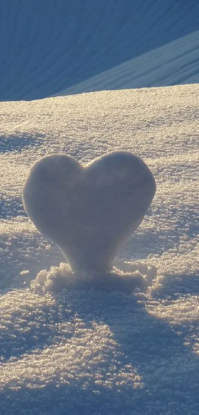 Heart-shaped snow sculpture on light blue textured background.