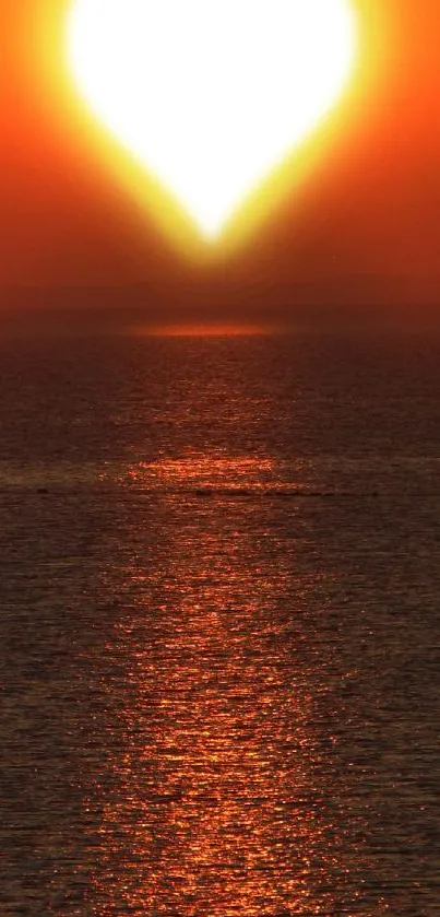 Heart-shaped sunset over ocean, serene.