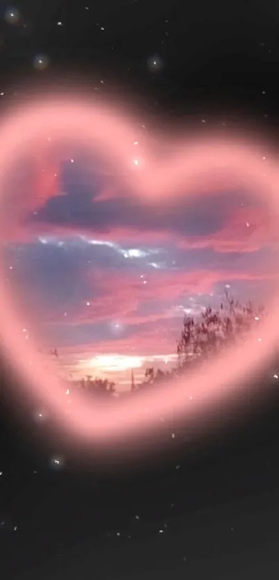 Heart-shaped pink glowing sunset sky on black background wallpaper.