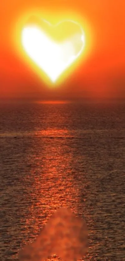 Heart-shaped sunset over ocean with orange sky.