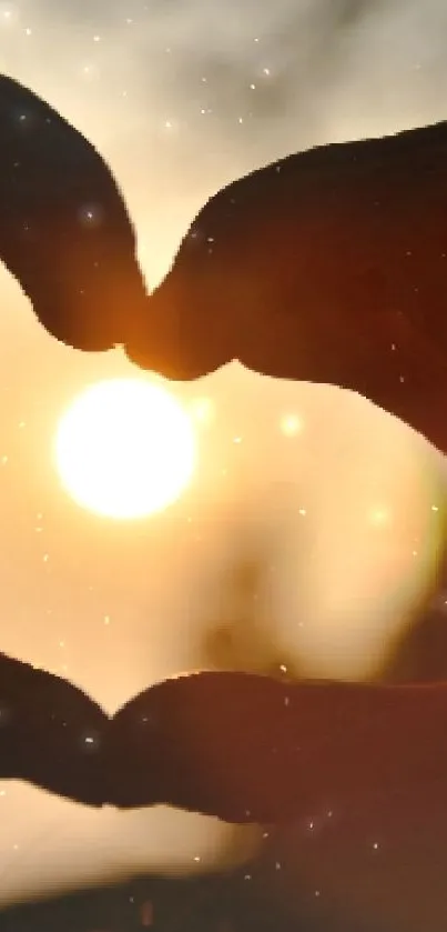 Heart-shaped hand silhouette at sunset with dark orange glow.