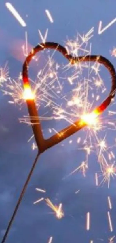 Heart-shaped sparkler lit against a twilight blue sky background.