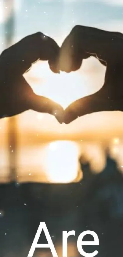 Heart hands silhouette with stunning sunset view.