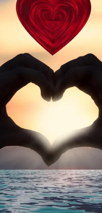 Hands forming heart at sunset with ocean and heart symbol in sky.
