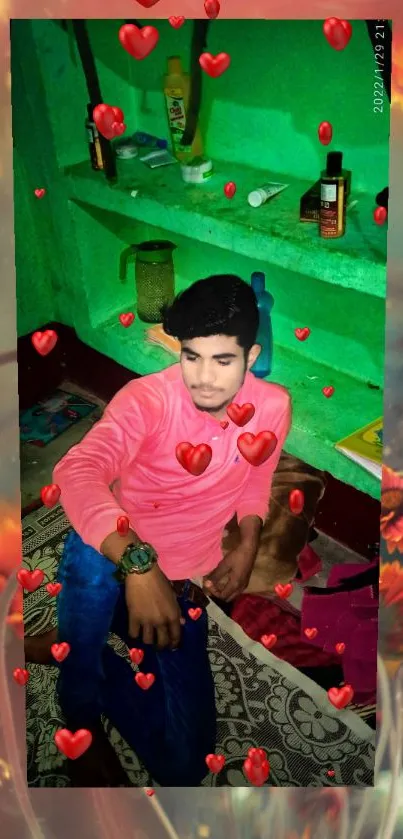 Young man in pink shirt with heart overlay on green background.