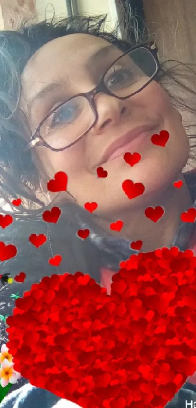 Woman with glasses and red hearts on mobile wallpaper.