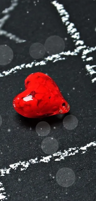 Heart-shaped tic tac toe with red hearts on a chalkboard background.