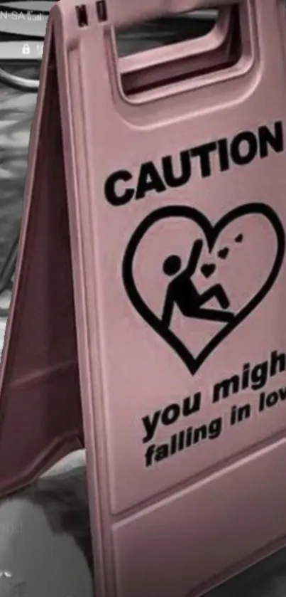 Pink caution sign wallpaper with a heart and love warning.