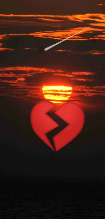 A broken heart over a fiery sunset sky.