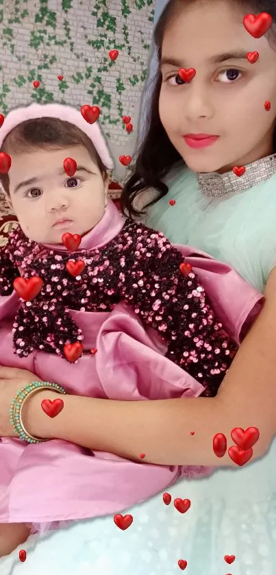 Two sisters in pink and blue attire with heart overlays.