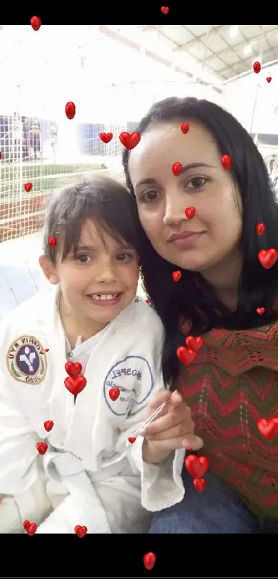 Mother and daughter portrait with heart decorations and cozy setting.