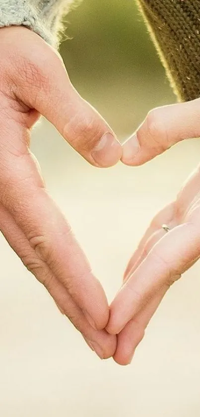 Hands forming a heart in gentle lighting, symbolizing love.