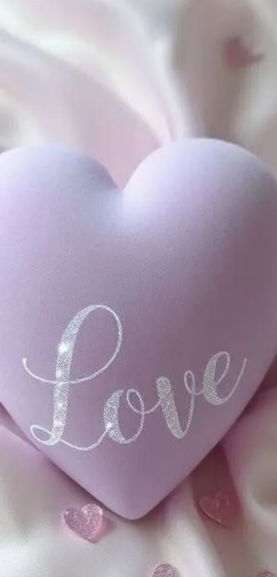 Pastel pink heart with 'Love' text on silky background.