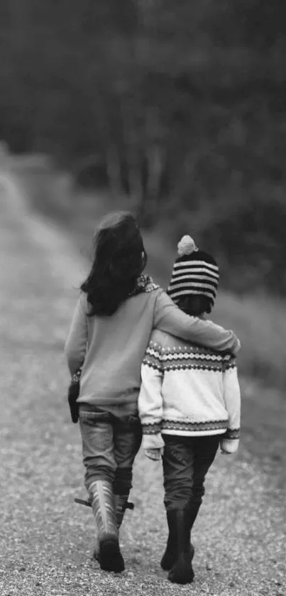 Two kids walking arm in arm on a serene path in black and white.