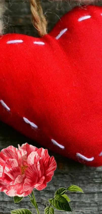 Red fabric heart with flower design on wood background.