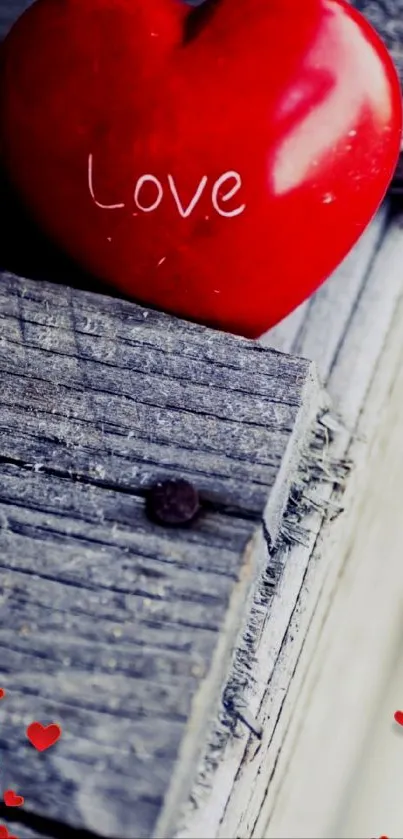 Red heart with 'Love' on rustic wood background, romantic design.